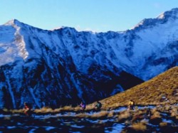 4 people riding bicycles in a mountainous landscape